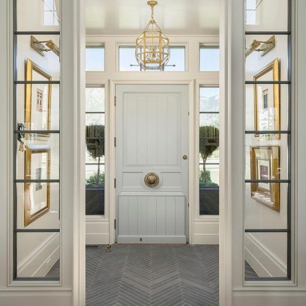 a glassed-in entryway with chandelier