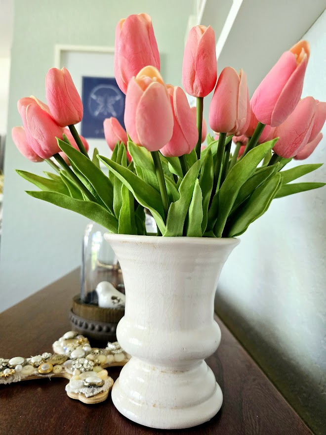 pink tulips in a white vase