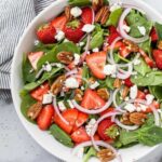 a bowl of strawberry spinach salad spring family dinners