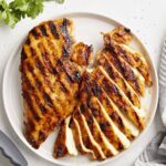 a plate of sliced grilled chicken spring family dinners