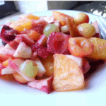 a white plate with fruit salad with rhubarb