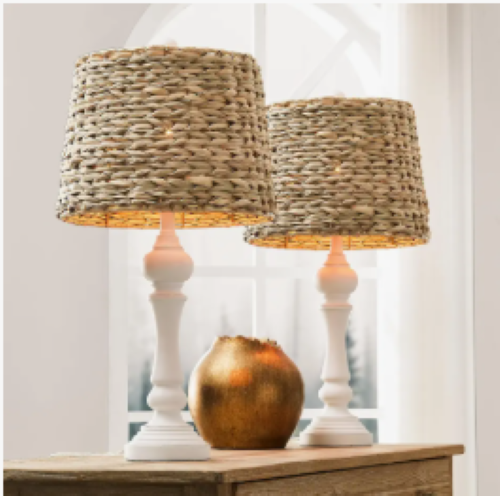 two white wooden base table lamps with a natural rattan shade