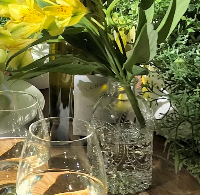 glasses on a tablescape with flowers summer decorating for small spaces