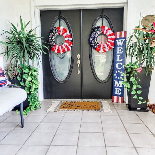 twin black entry doors with oval windows and patriotic decor get your home ready for summer