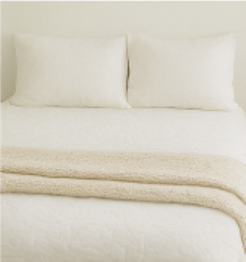 a bed with white linens
