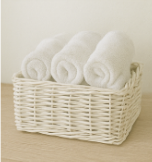 a wicker basket with white towels rolled up inside how to add a relaxing summertime vibe to your home