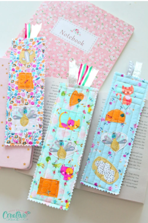 a set of 3 bookmarks made from fabric and ribbons