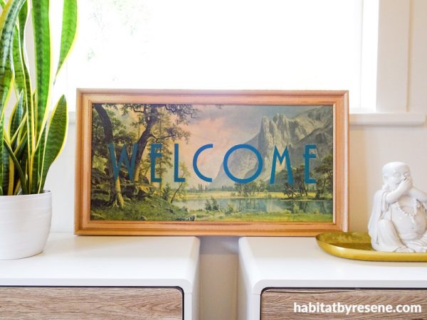 A small framed welcome sign on a table make your entryway more inviting