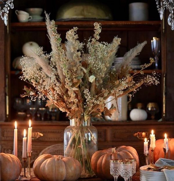 fall centerpiece with dried flowers and pumpkins