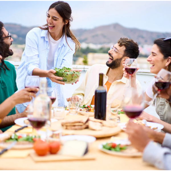 a group of people sitting outside eating a meal