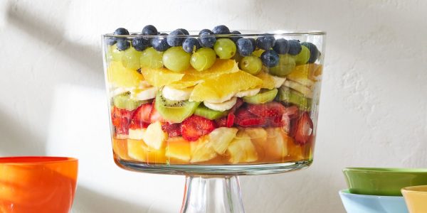 a compote dish full of fresh fruit