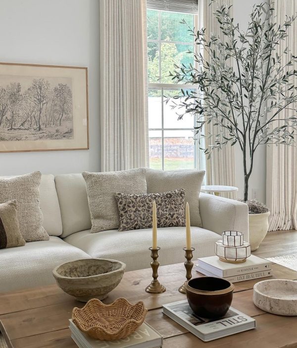 white living room with large art and large tree