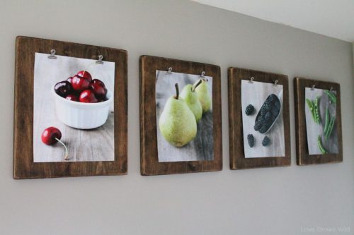 a series of 4 pictures of fruit framed and hanging on a wall