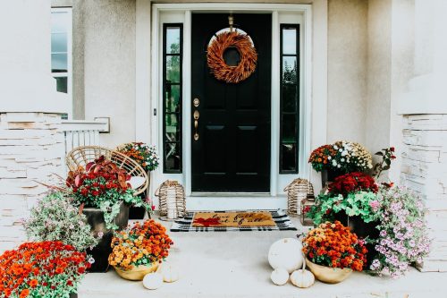 Front porch with mums and pumpkins