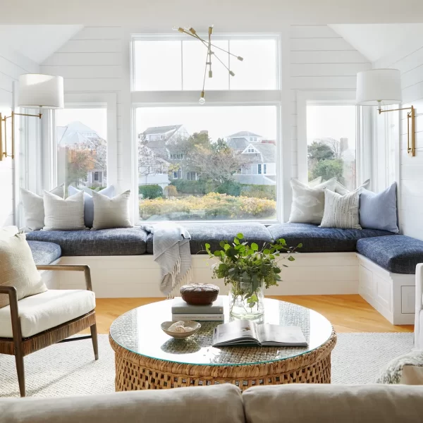 White living room with blue upholstery and large window