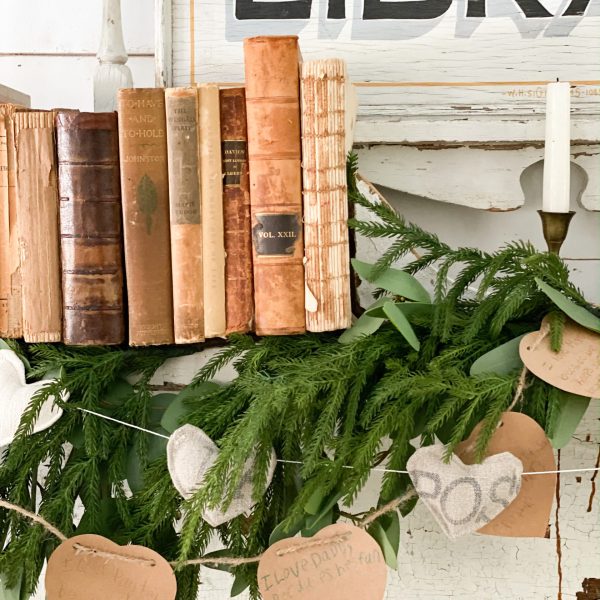 antique books with greenery and paper hearts