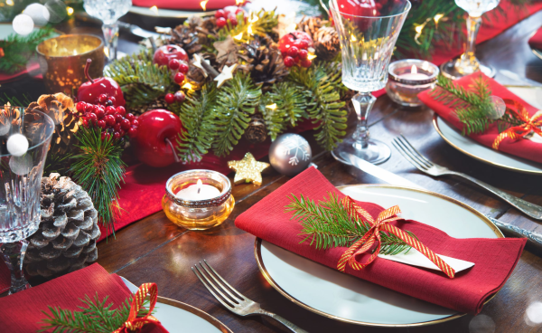 Christmas table with red napkins and greenery