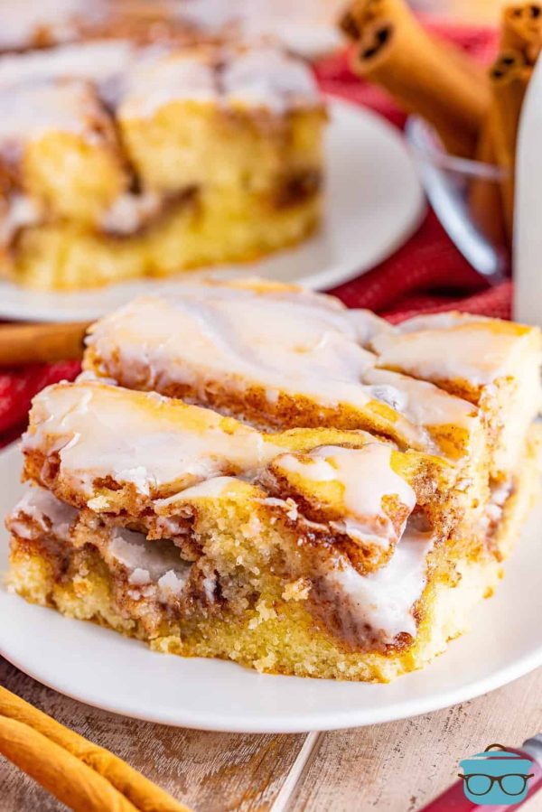 a square of cinnamon roll cake on a white plate