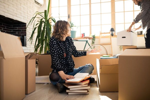 A couple packing things into boxes