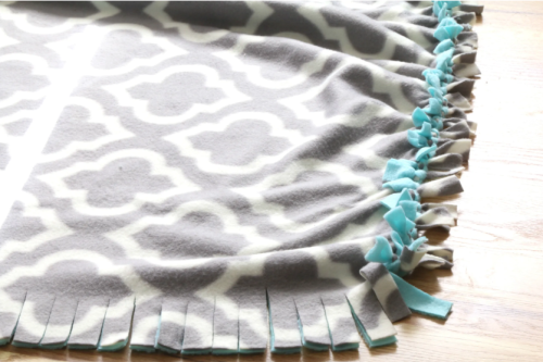 a hand-tied fleece blanket partially completed