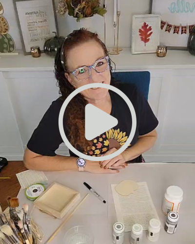 a woman sitting at a table on a video