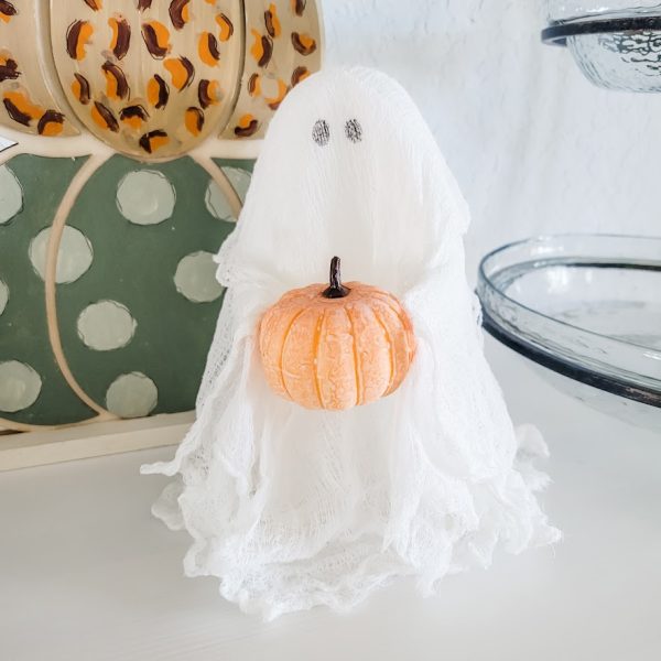 halloween cheesecloth ghost holding a tiny pumpkin