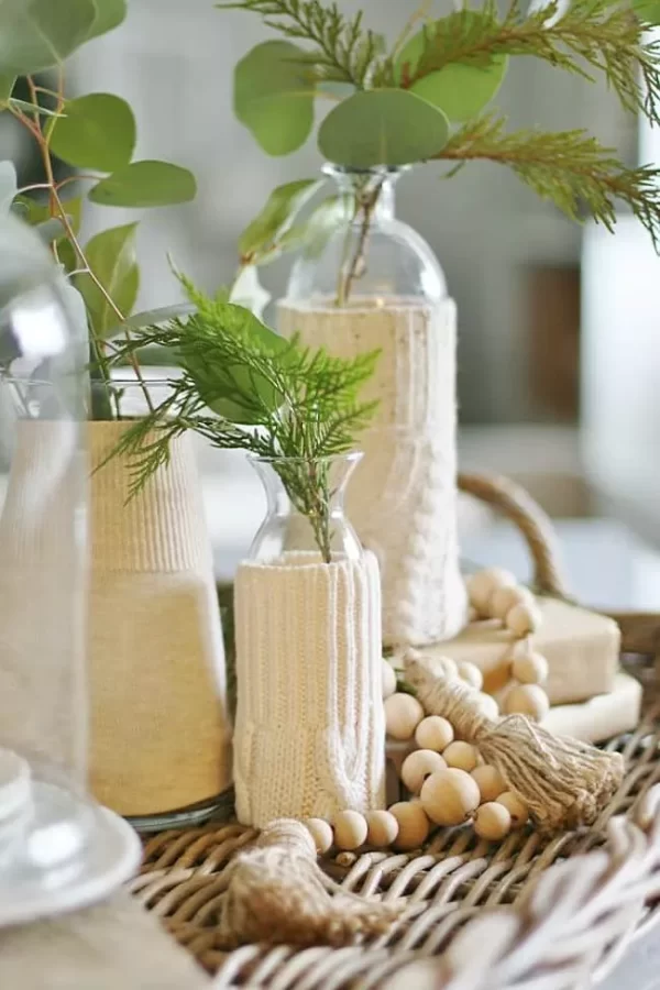 candles on a table with plants