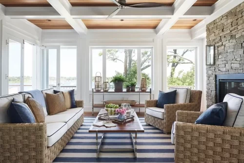 white living room with blue and white striped rug and large windows