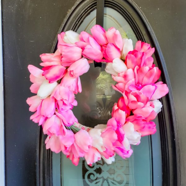 Pink tulip wreath on a black door my Easter home tour