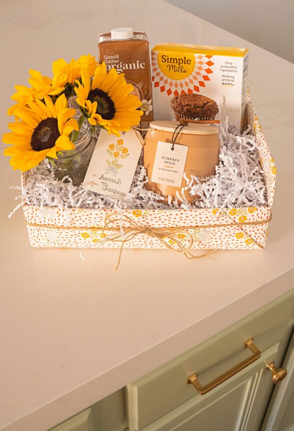 a gift basket with a sunflower, a candle and a muffin mix frugal gift ideas