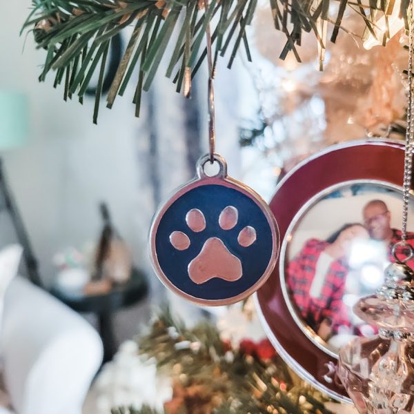 a dog paw print ornament on the Christmas tree