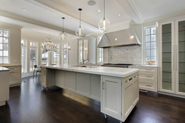 white litched with 3 pendant lights over the island the rule of three