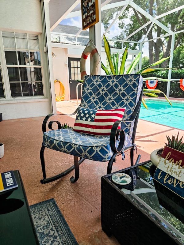 cushioned rocker with an American flag pillow summer porch decor ideas