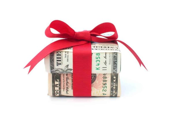 two rolls of paper money tied with a red ribbon