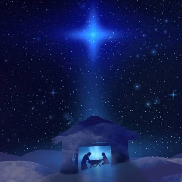 Blue background with a bight light and the nativity below.