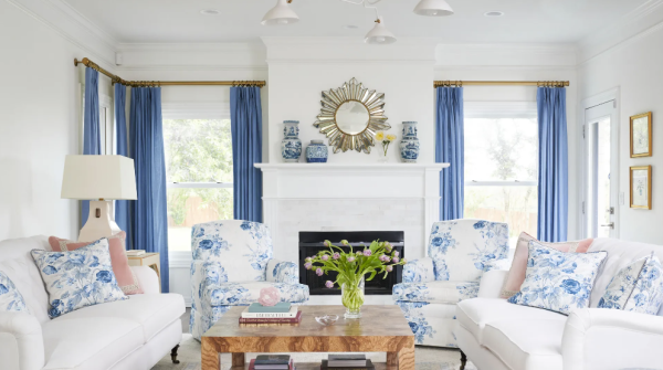 White living room with blue curtains and blue accents in the home decor