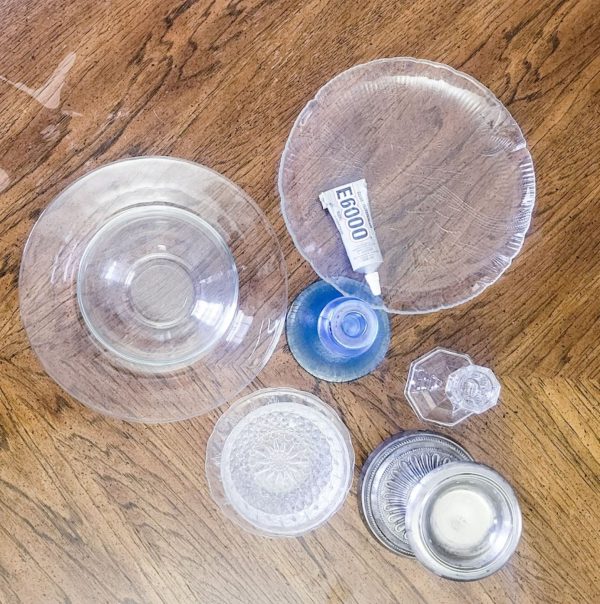 a grouping of glass dishes on a wood table