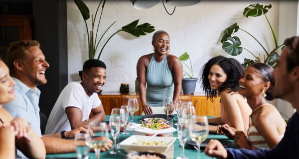 Adults have a great time laughing while having dinner