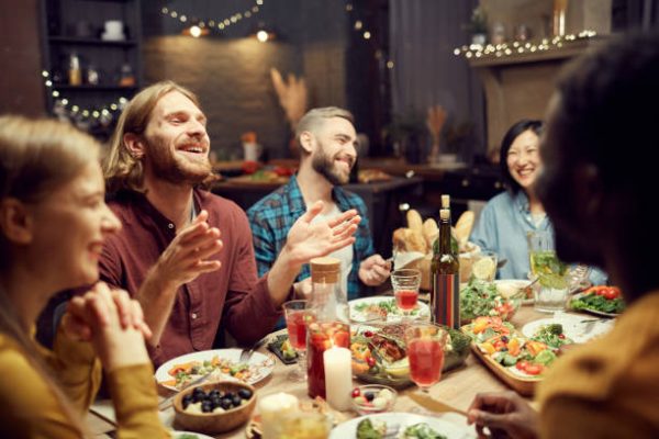 adults laughing at the dinner table