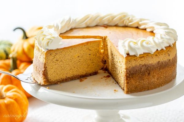 a pumpkin cheesecake on a white plate with a few slices missing fabulous fall desserts