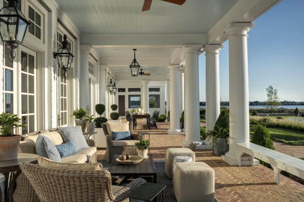 porch with white columns and wicker furniture the beauty of simplicity in home decor