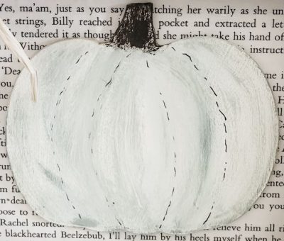 close up of wooden pumpkin cutout painted