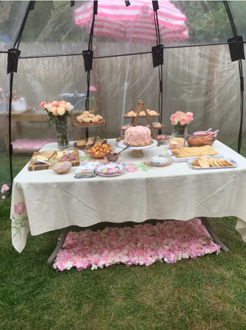 a dessert table set up in a tent due to rainy weather planning the perfect spring garden party