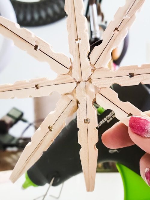 Snowflake-clothespin-Christmas-ornament-DIY-showing-glue-on-back