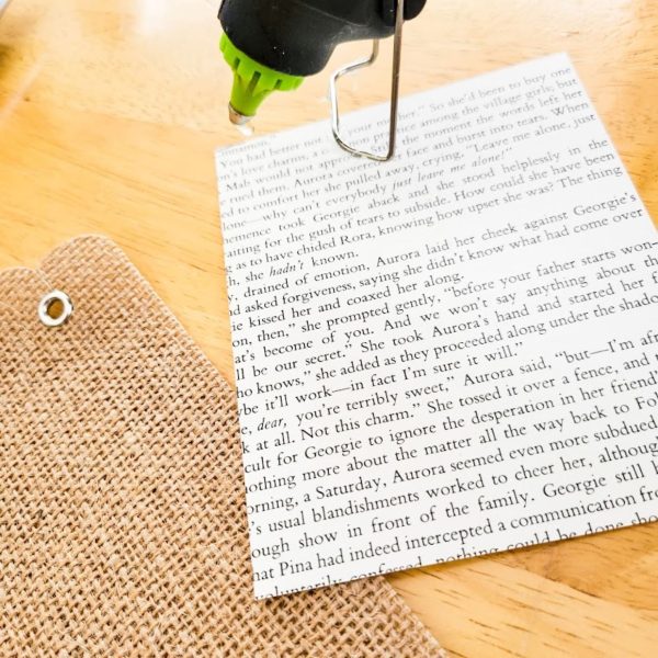 adding hot glue to a paper how-to-make-a-garland-out-of-printables-adding-hot-glue-to-book-pages