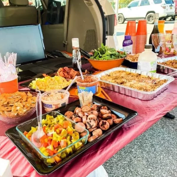 Buffet of tailgating foods set up on the back of an SUV