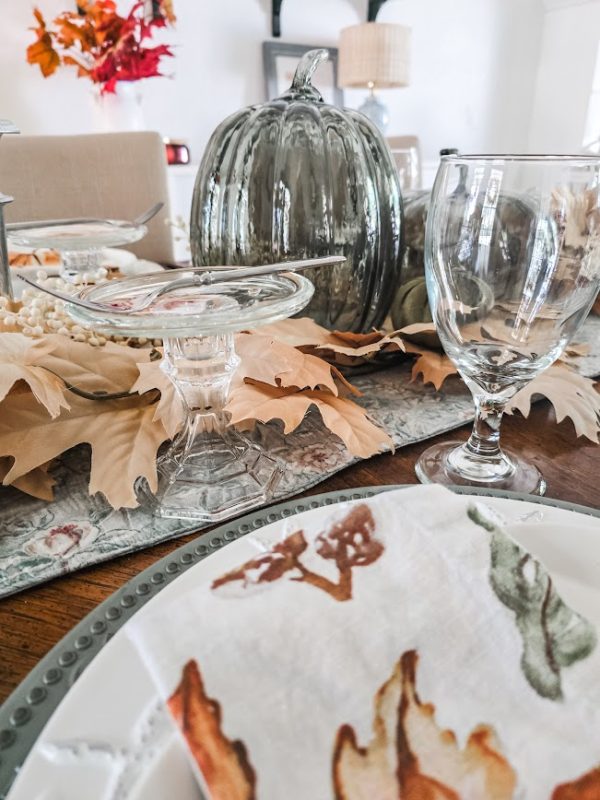 a stemmed glass and dessert plate sitting at the place setting crafting the perfect tablescape