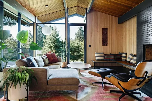 living room with wood paneling and large windows