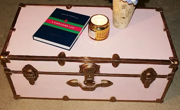 pink steamer trunk with a book and a candle DIY extends beyond arts and crafts