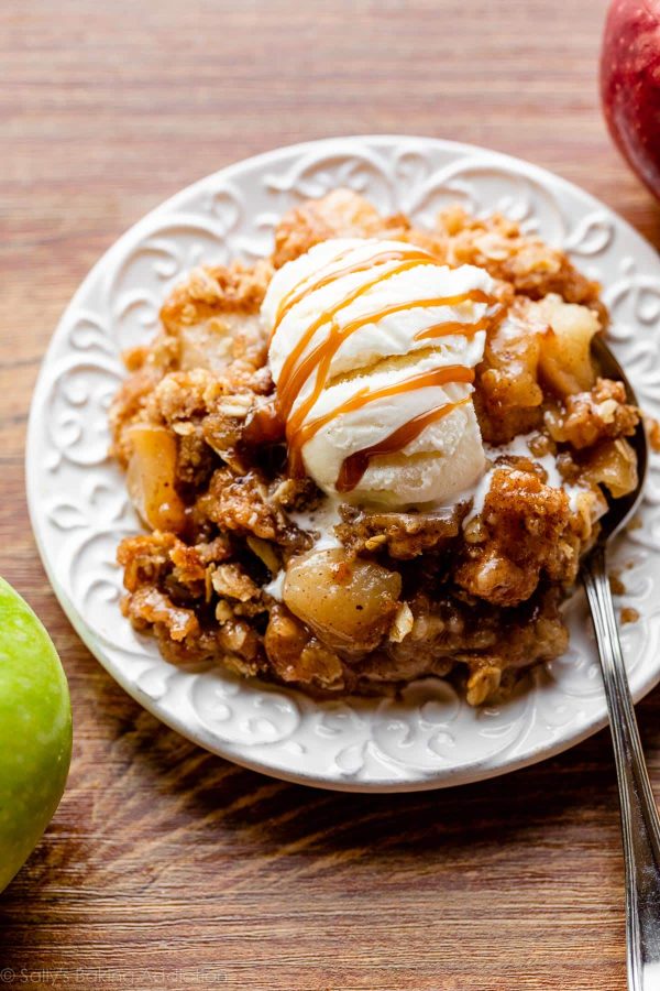 apple crisp with vanilla ice cream on a white plate